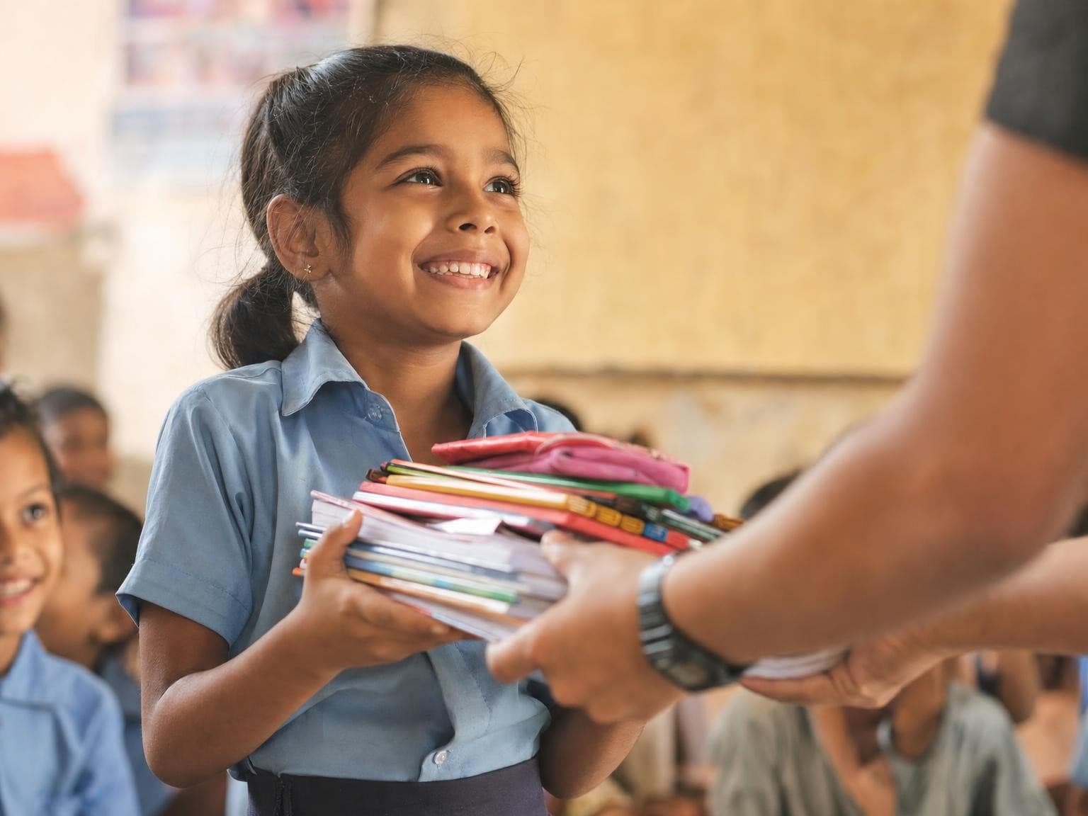 A schoolchild happily receiving new books and school supplies